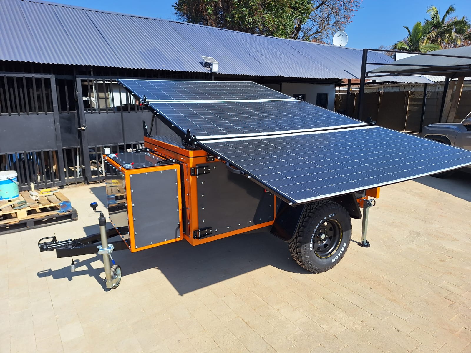 Rollout trailer with Sunman panels deployed, front-quarter view