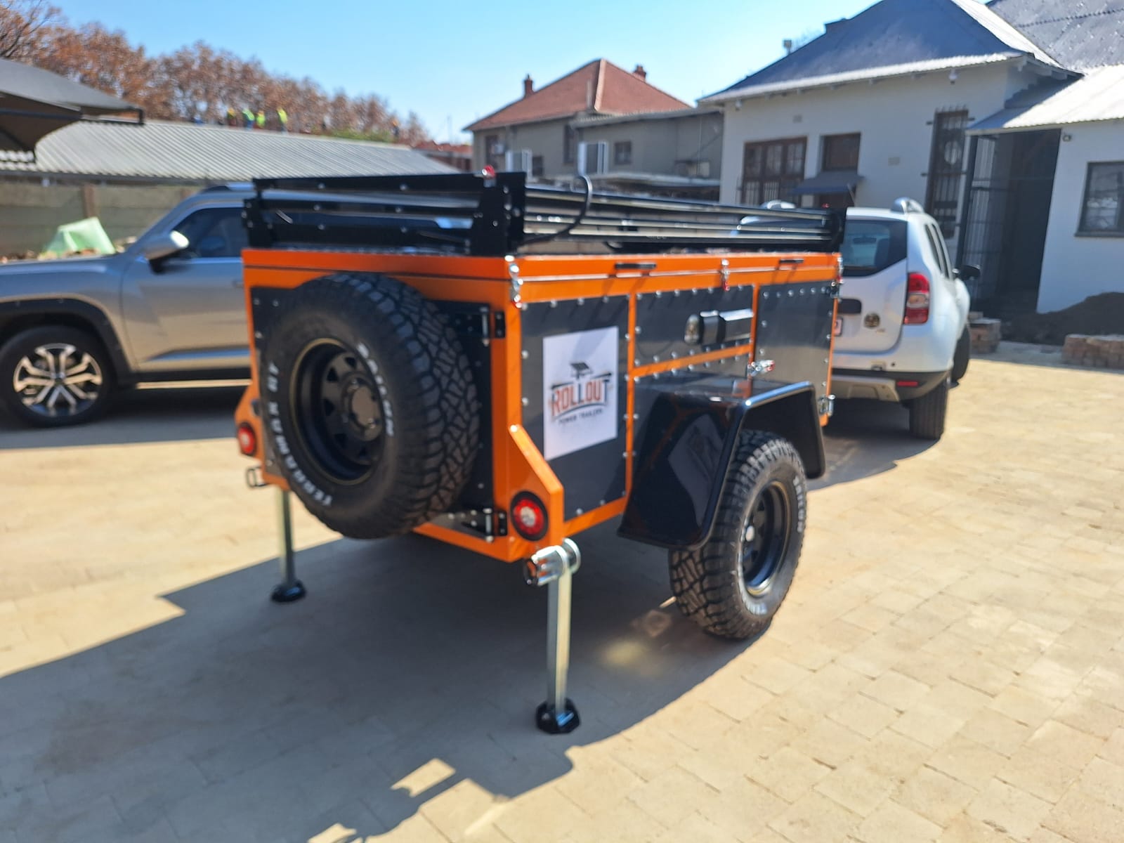 Rollout trailer rear view with spare wheel and support legs