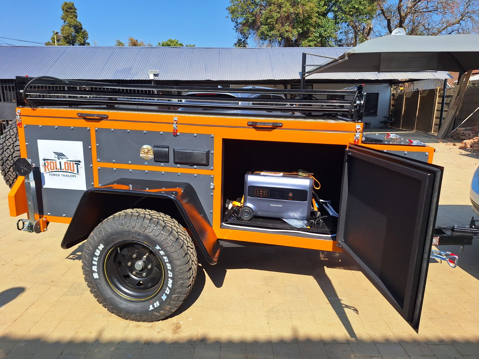 Rollout trailer side compartment open showing Runhood power station